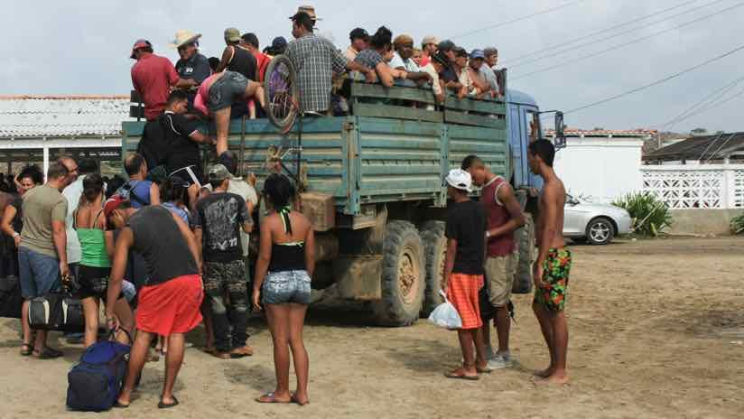 central american refugees board a truck