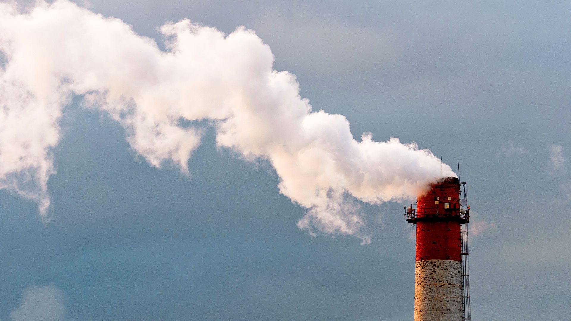 A smokestack signals air pollution and its business impacts