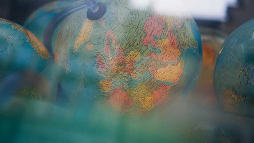A desktop globe indicates a geographic approach to business growth